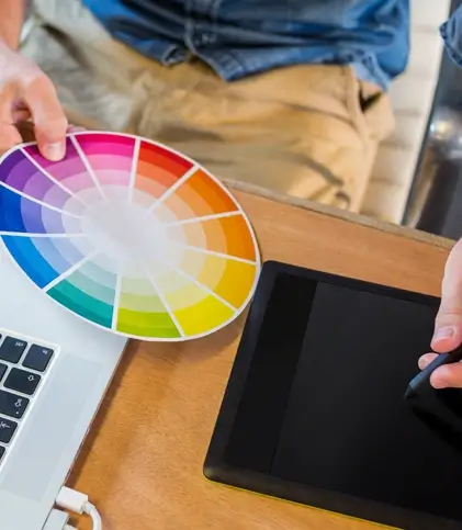 Picture of a designer using stylus and a color wheel